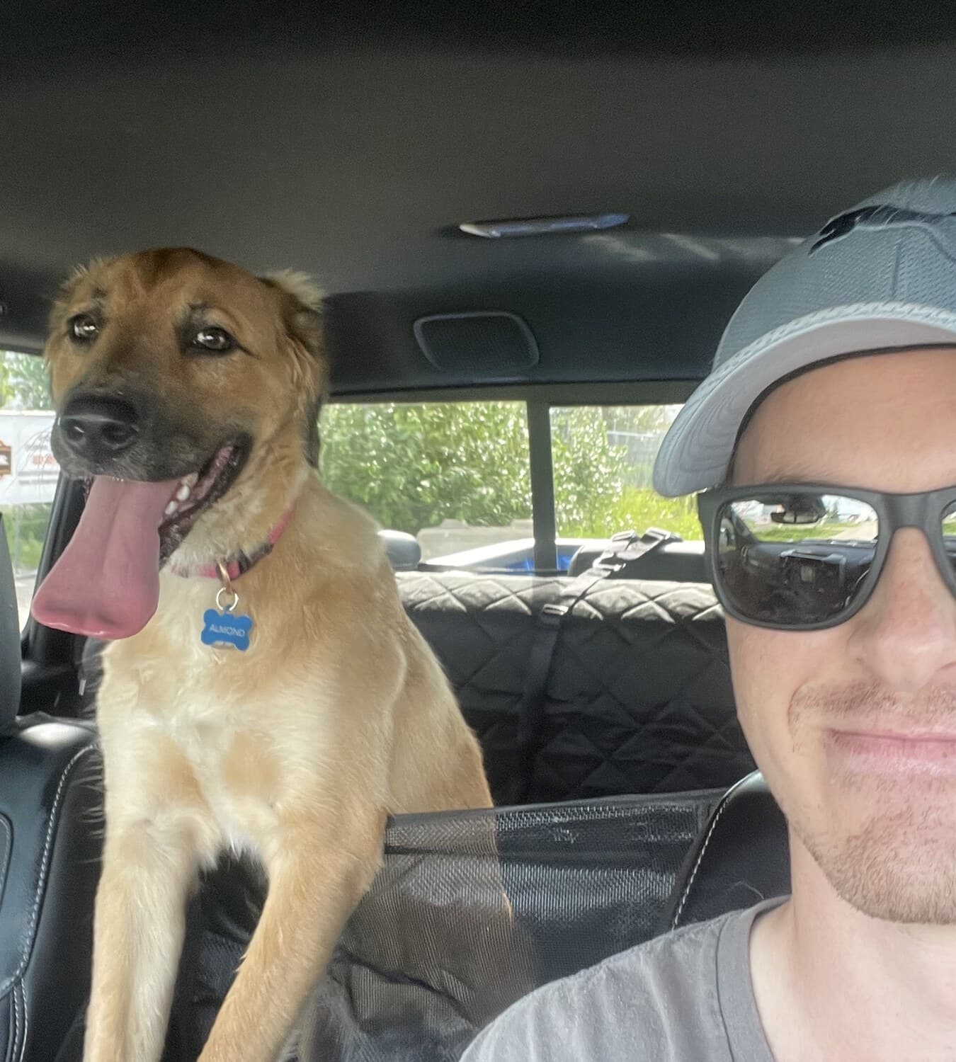 Austin sitting in a car with Almond.