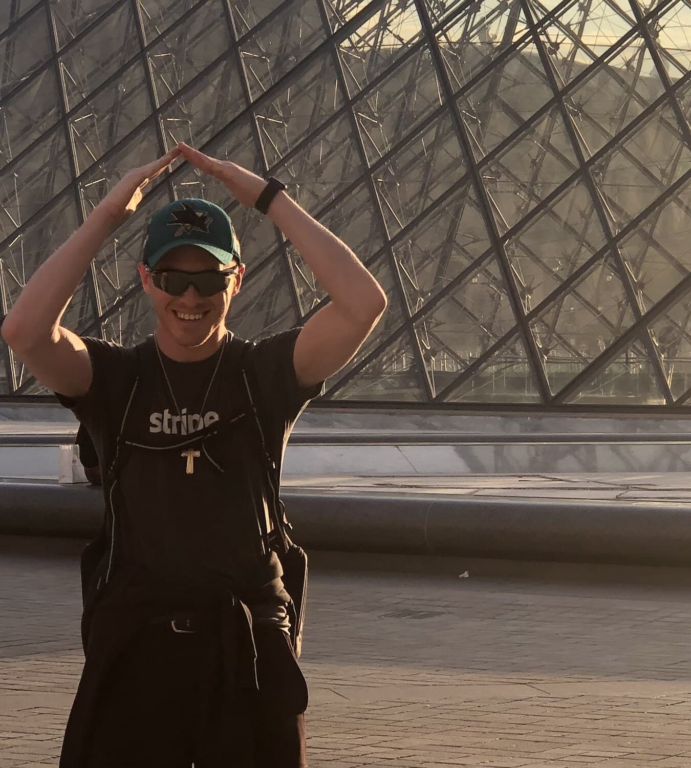 Austin standing in front of the Louvre Pyramid in Paris.